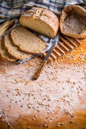 Homemade whole bread on wooden background