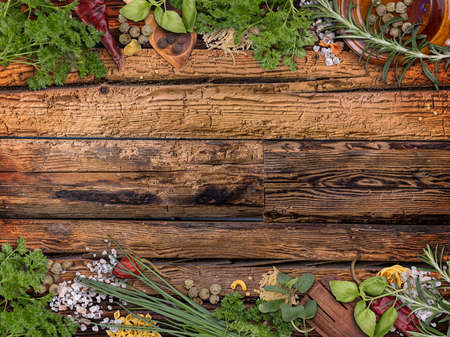 Herbs frame on weathered wooden boardの写真素材