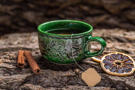 Cup of tea on a wooden bark backgroundの写真素材