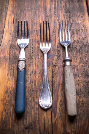Vintage silverware on rustic wooden background