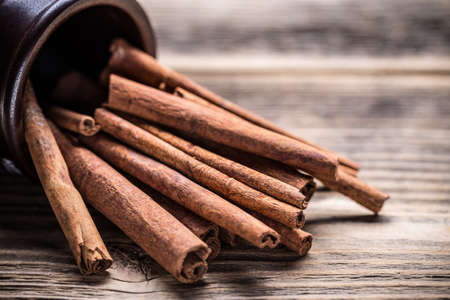 Cinnamon sticks on wooden backgroundの写真素材