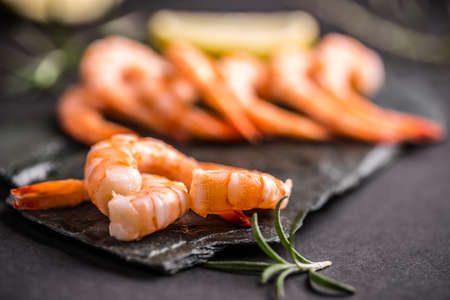 Raw prawns on black slate