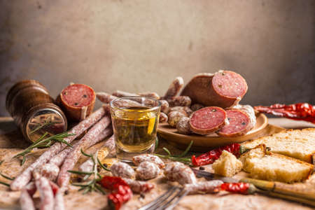 Different sorts of salami on vintage backgroundの写真素材
