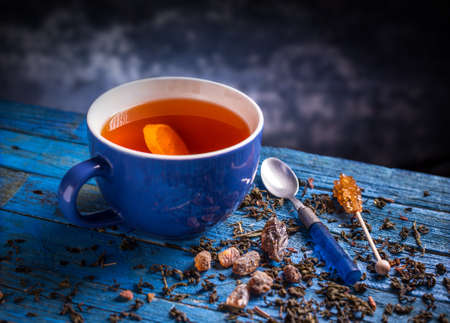 Cup with black tea on blue wooden backgroundの写真素材