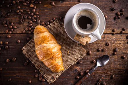 Coffee and croissant on wooden backgroundの写真素材