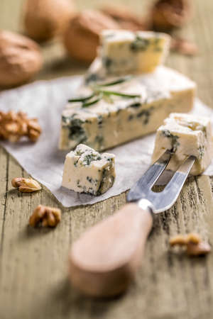 Slices of danish blue cheese on wooden backgroundの写真素材