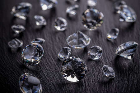 Photo of diamonds on dark metal surfaceの写真素材