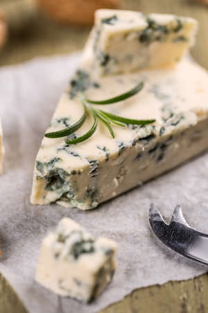 Tasty blue cheese with walnut on crumpled paperの写真素材