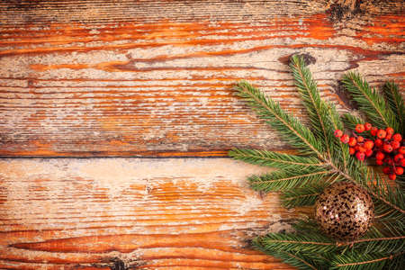 Fir tree with christmas decorations on the rustic wooden backgroundの写真素材