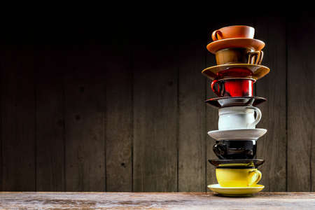 Color cups on a wooden background with space for your text