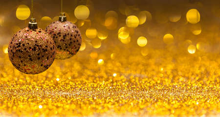 Christmas background with balls of golden colorの写真素材