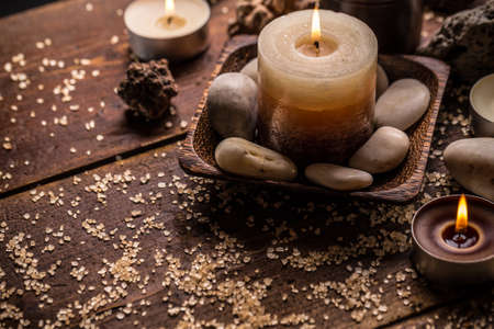 Burning candles on wooden surfaceの写真素材