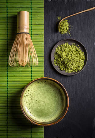Still life with Japanese matcha accessories and green tea in bowlの写真素材