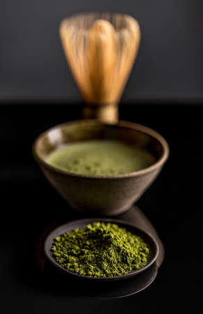 Organic green matcha tea on black backgroundの写真素材