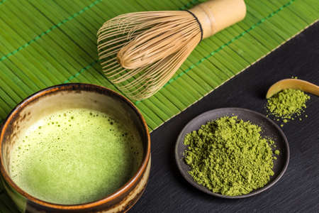 Still life with Japanese matcha accessories and green tea in bowlの写真素材