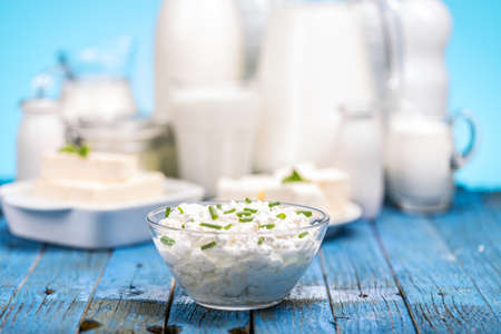 Cottage cheese with chives in glass bowlの写真素材