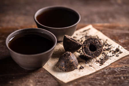 Still life with pressed pu-erh tea and crockery tea set