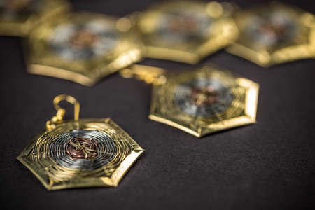 Hexagonal earring on black background