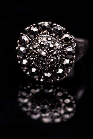 Ring decorated with small stones on black backgroundの写真素材