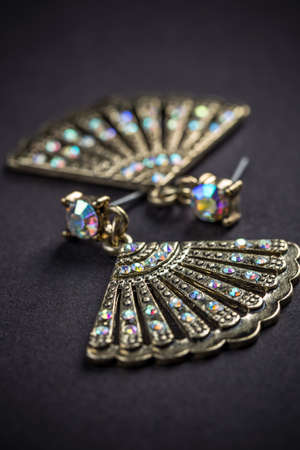 Fan shaped metal earrings with colored stonesの写真素材