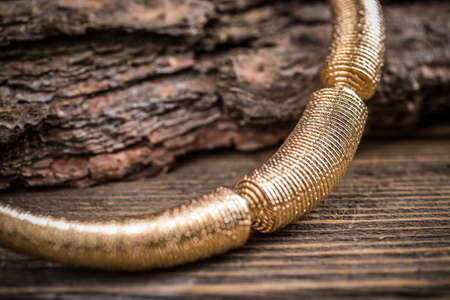 Metal feminine necklace on rustic wooden backgroundの写真素材