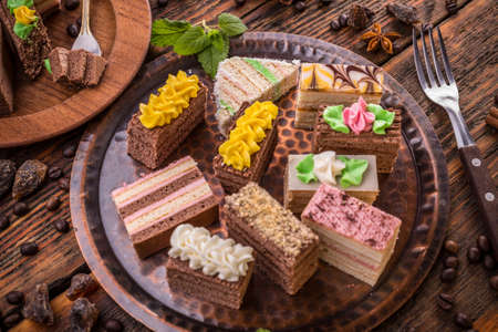 Assorted different mini cakes with creamの写真素材