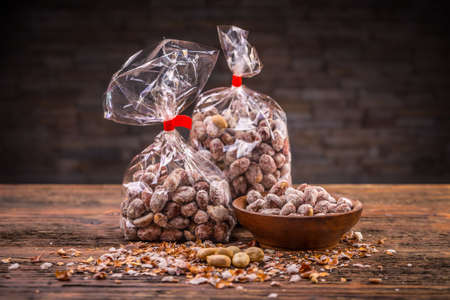 Salted roasted peanuts in wooden bowlの写真素材