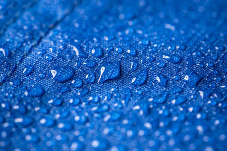 Rain water droplets on blue fiber waterproof fabricの写真素材