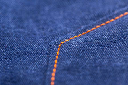Blue jeans pocket stitched with orange thread