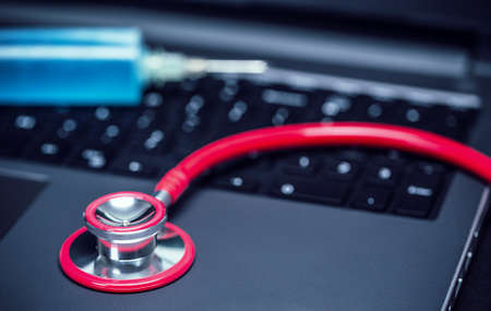 Close up of stethoscope on laptop keyboardの写真素材