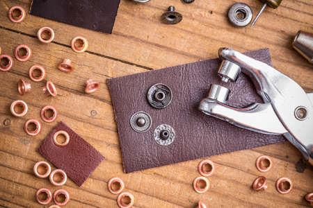 Tailor workplace with pieces of leather and rivetsの写真素材