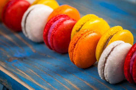 Cake macaron or macaroon on blue wooden backgroundの写真素材