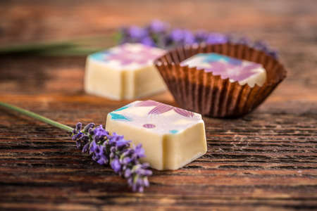 Delicious chocolate pralines on wooden backgroundの写真素材