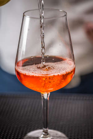 Pouring alcohol into glass, beverage conceptの写真素材