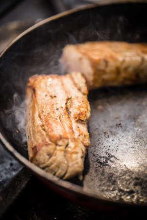 Loin pork meat cooked in a frying panの写真素材