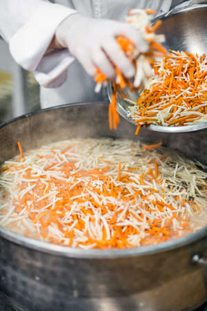 Chef at work, cooking vegetable for soupの写真素材