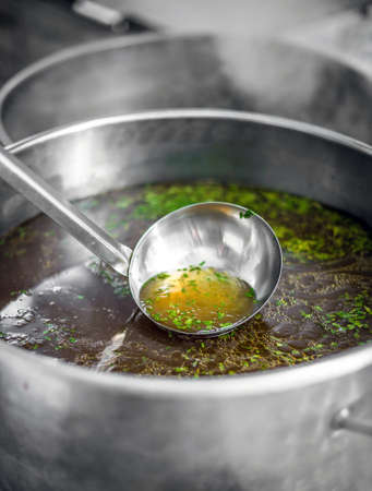 Chef at work, prepare clear soupの写真素材