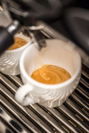 Coffee machine makes two coffeeの写真素材