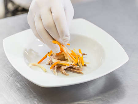 Chef preparing dishes for soup on the restaurant kitchenの写真素材