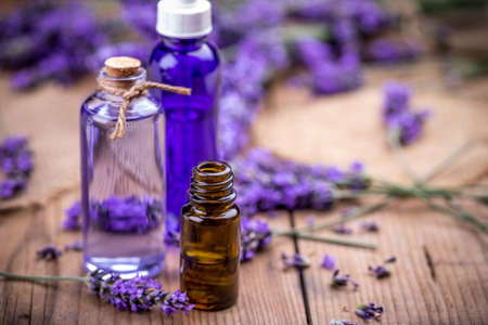 Bottles of essential oil and fresh lavender flowersの写真素材