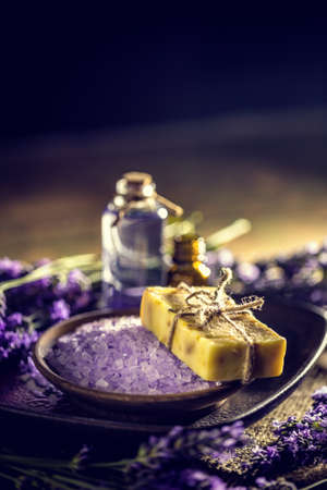 Beauty treatment concept with bath salt, bar of soap and essential oilの写真素材