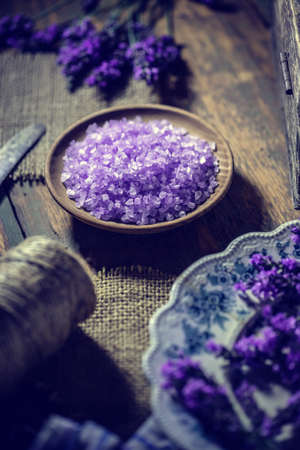 Bowl of lavender bath salt on vintage wooden backgroundの写真素材