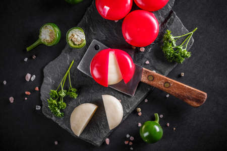 Round delicious cheese covered with red waxの写真素材