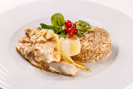 Grilled sablefish or butterfish serving with arpacas (husking and refining wheat, spelt, barley or millet)の写真素材
