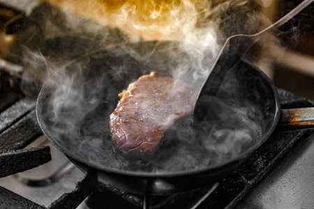 Close up of beef steak frying in panの写真素材