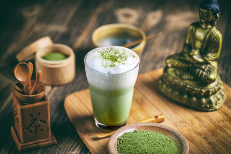 Still life with Japanese matcha accessories and matcha tea latte in glassの写真素材