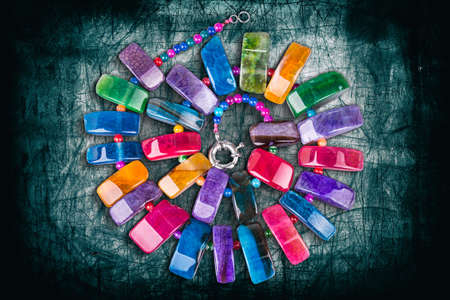 Colorful stones necklace on damaged metal backgroundの写真素材