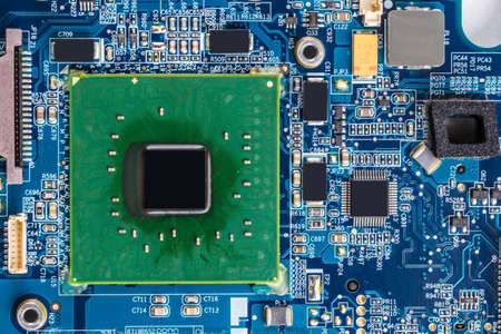Modern printed circuit board with electronic components macro background
