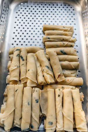 Salted tarragon pancake for garnish on silver tray in hotel or restaurant kitchenの写真素材