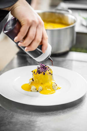 Restaurant workers prepare meals for serving at the tableの写真素材